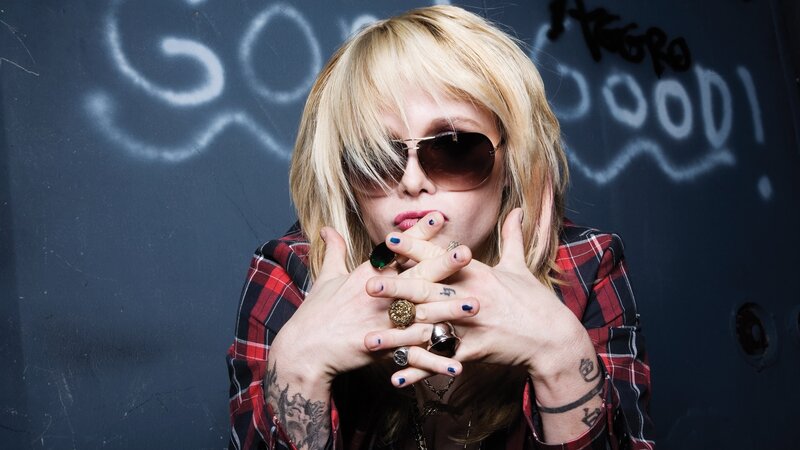 person with blonde hair and sunglasses
