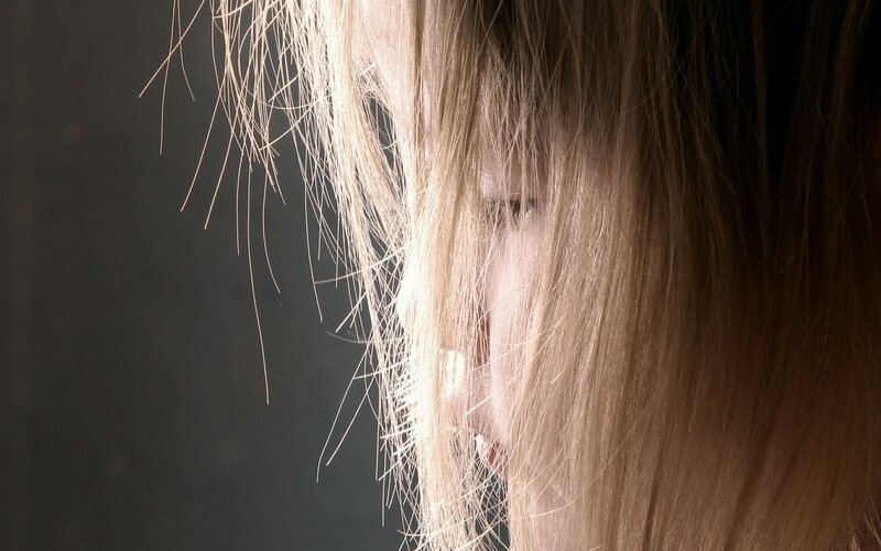 person with blonde hair in profile