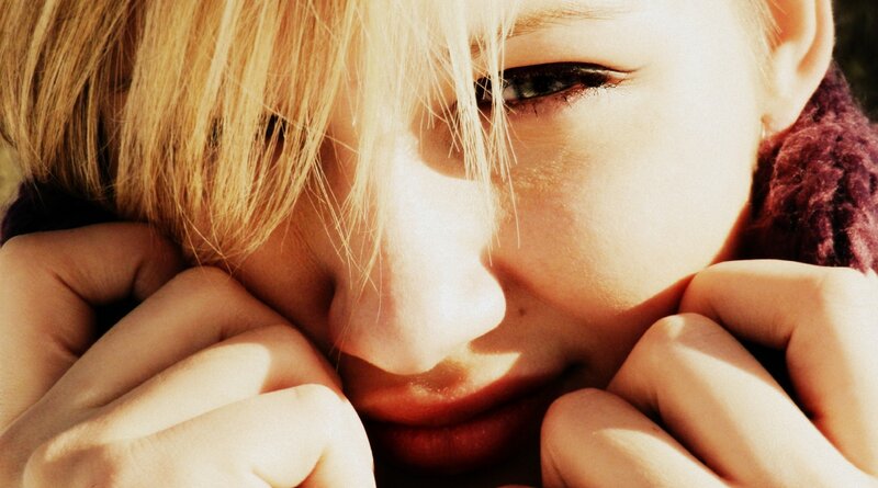 person with blonde hair in sunlight