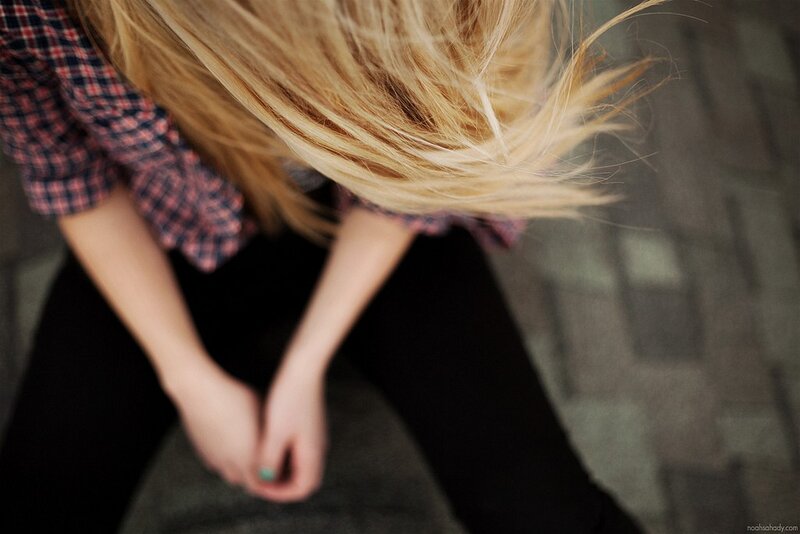 person with blonde hair sitting