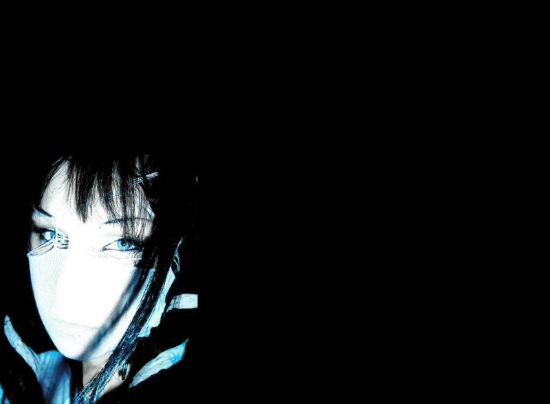 person with blue eyes and dark hair