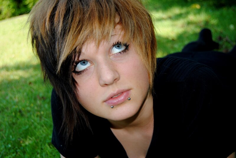 person with blue eyes and lip piercing