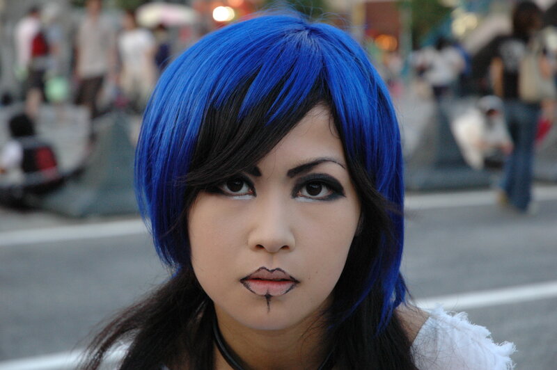 person with blue hair and makeup
