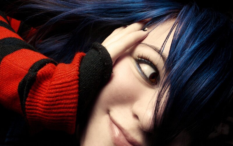 person with blue hair and red sweater