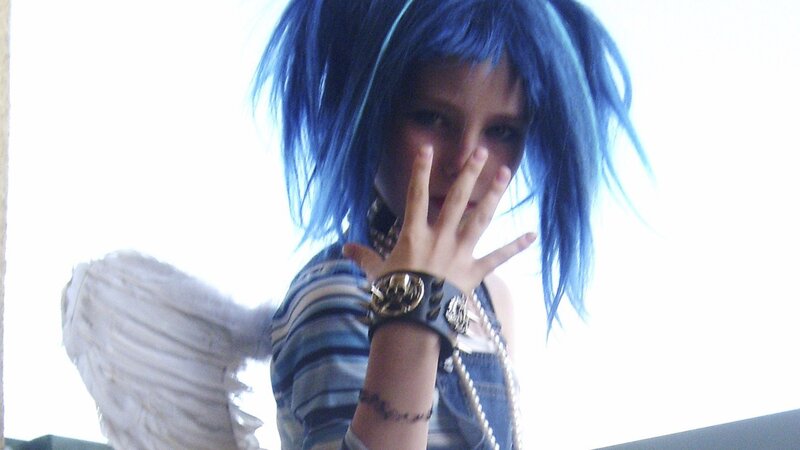 person with blue hair and wings