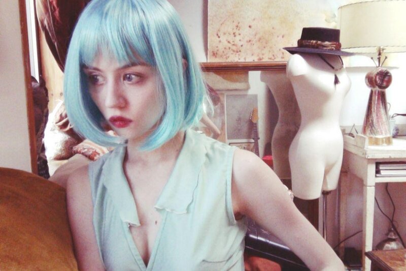person with blue hair in room