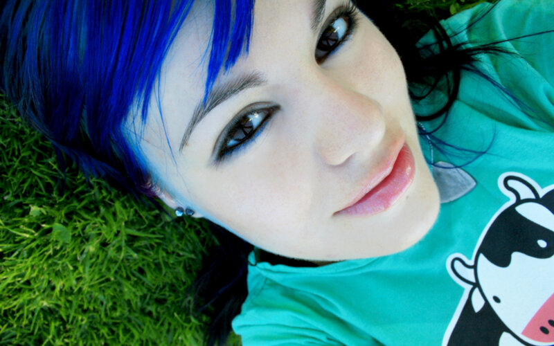 person with blue hair on grass