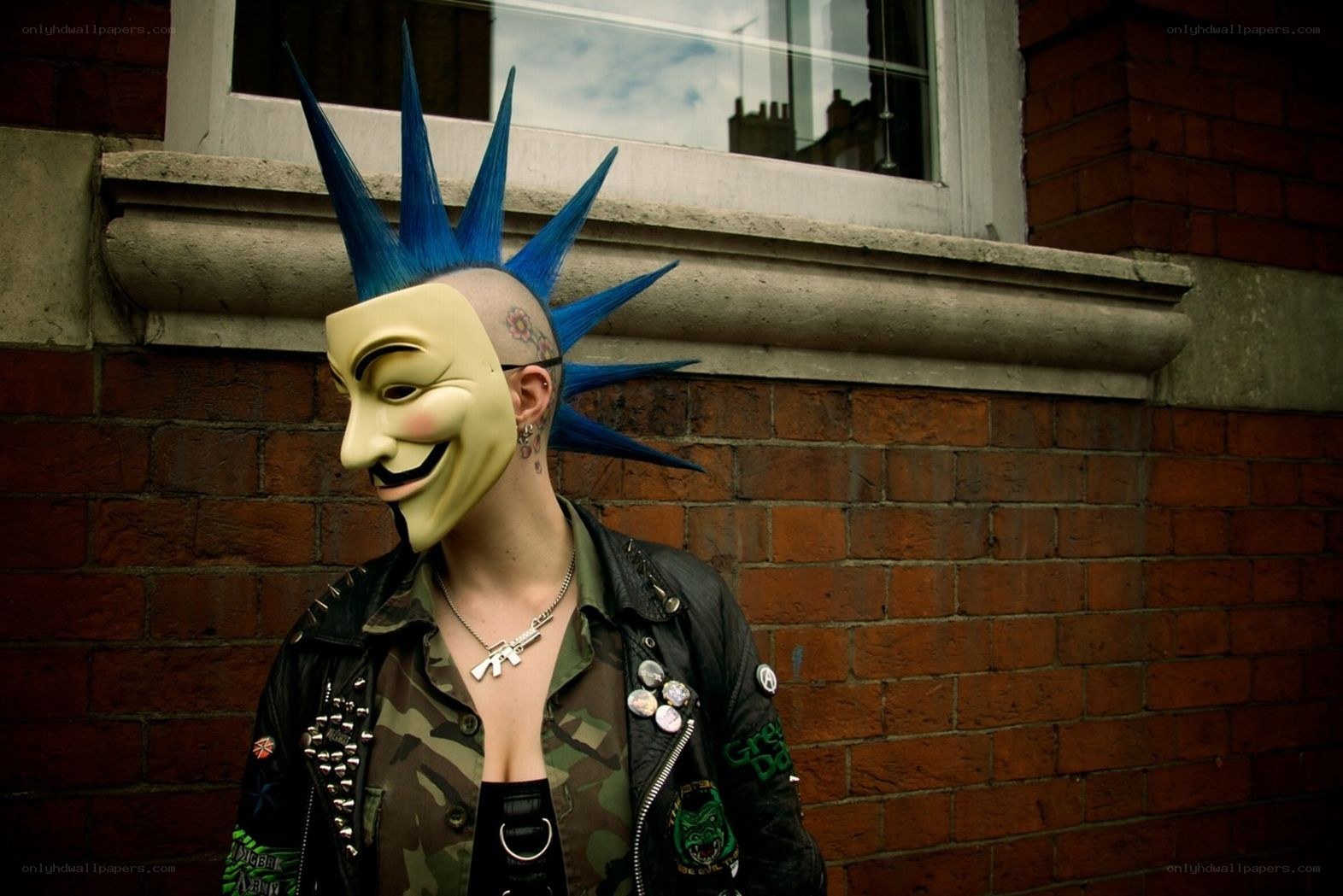 person with blue mohawk and mask