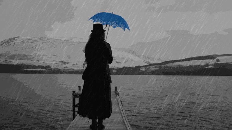 person with blue umbrella in rain