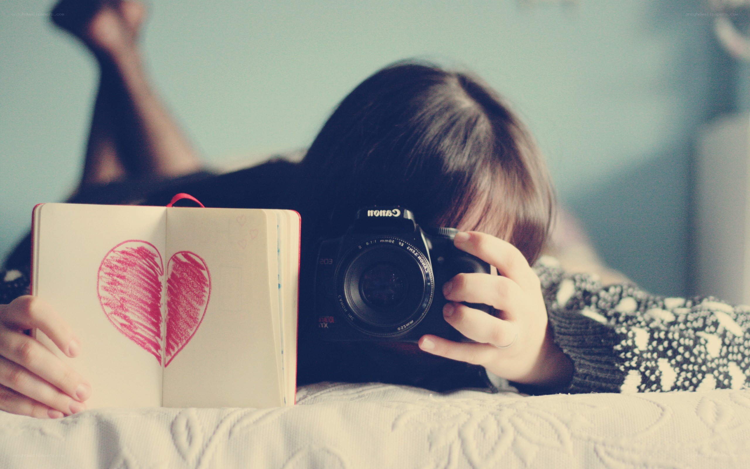 person with camera and heart notebook