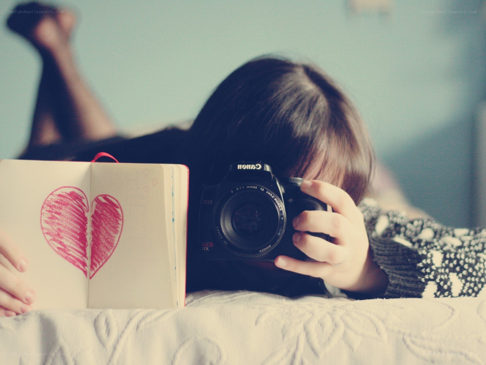 person with camera and heart notebook