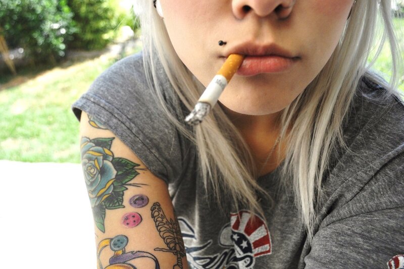person with cigarette and tattoos