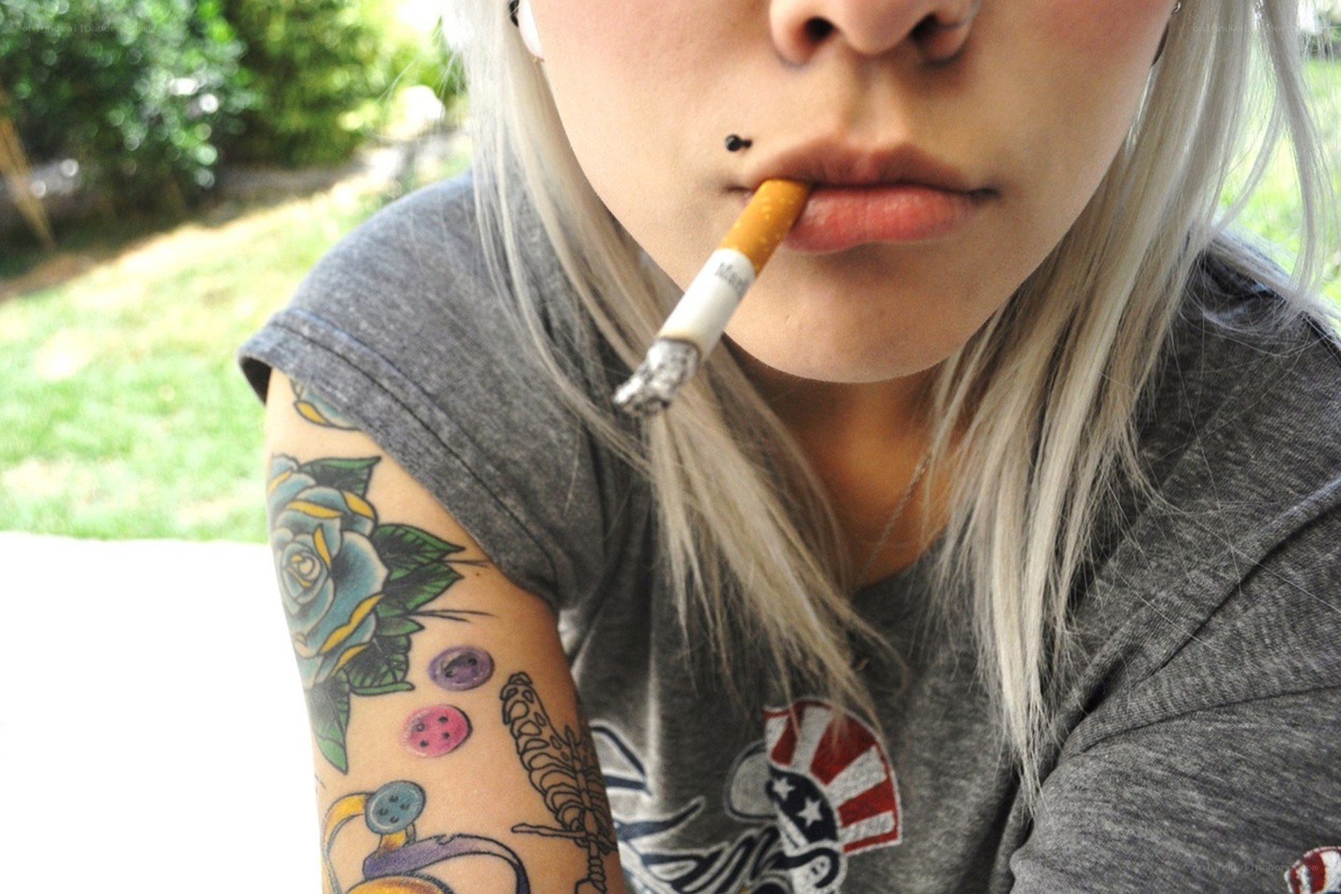 person with cigarette and tattoos