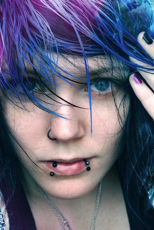 person with colorful hair and piercings