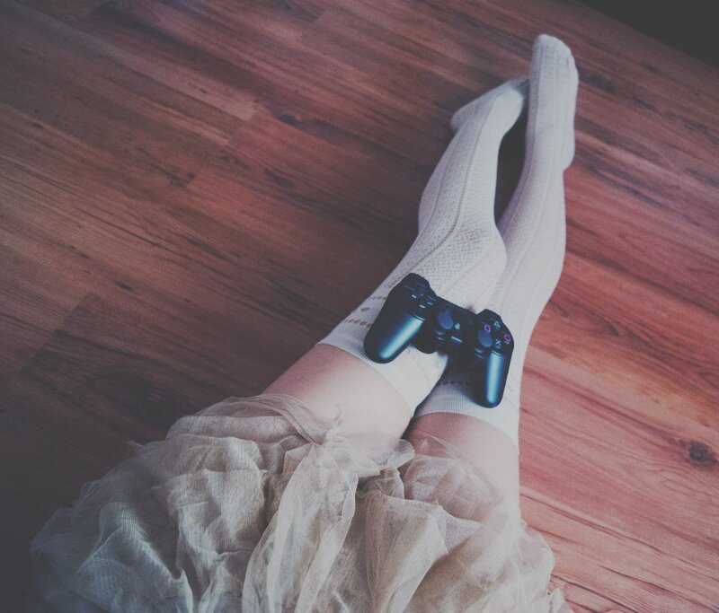 person with controller on legs