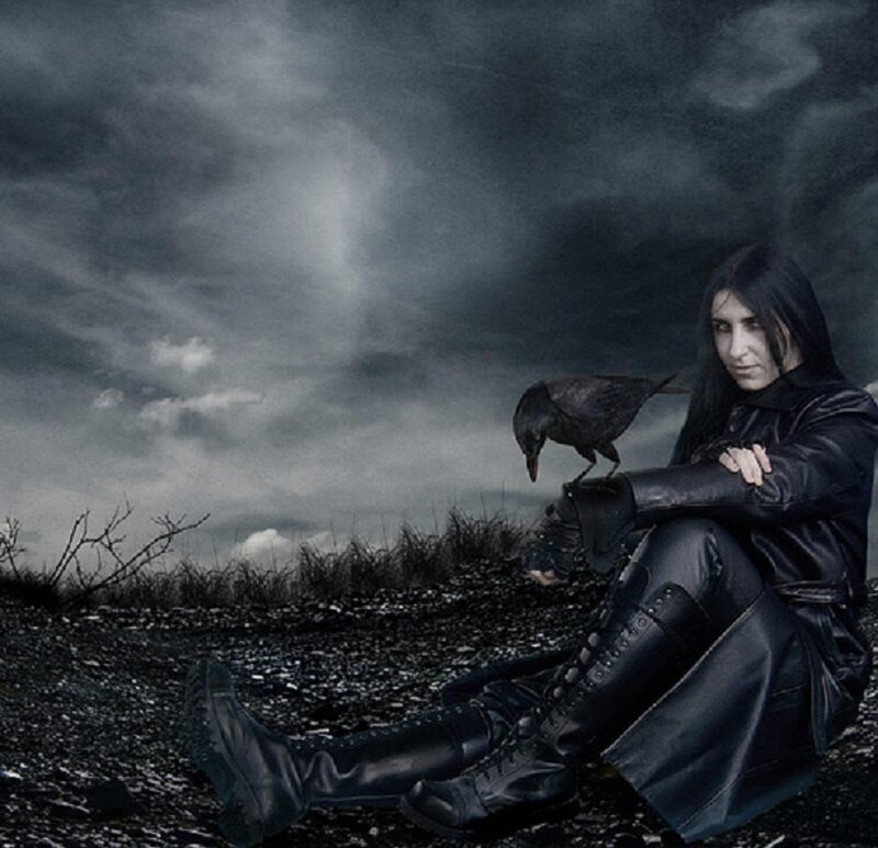 person with crow in dark landscape
