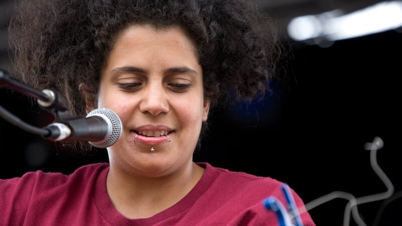 Person with Curly Hair Singing — Red