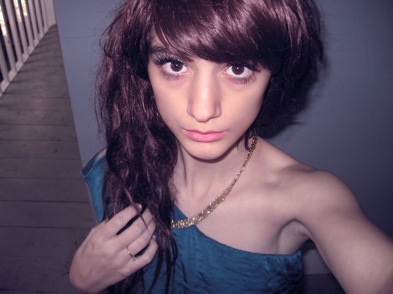 person with dark hair and blue top