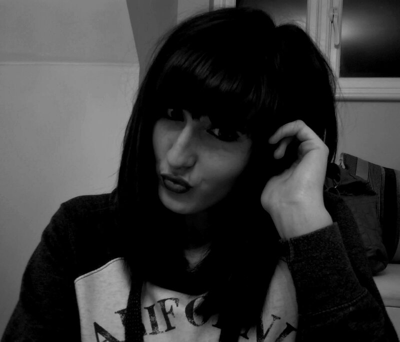 person with dark hair in black and white