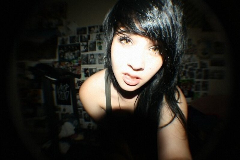 person with dark hair in dim room