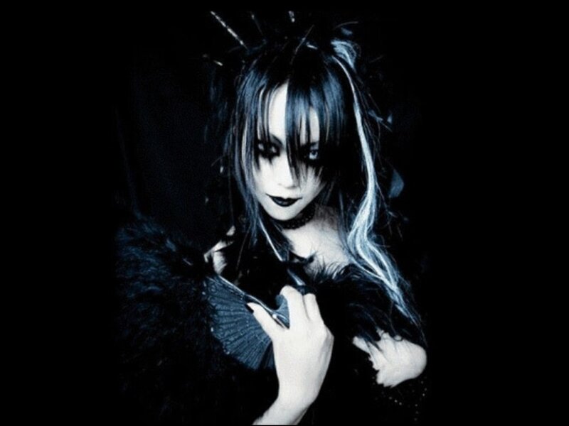person with dark makeup and black feathers