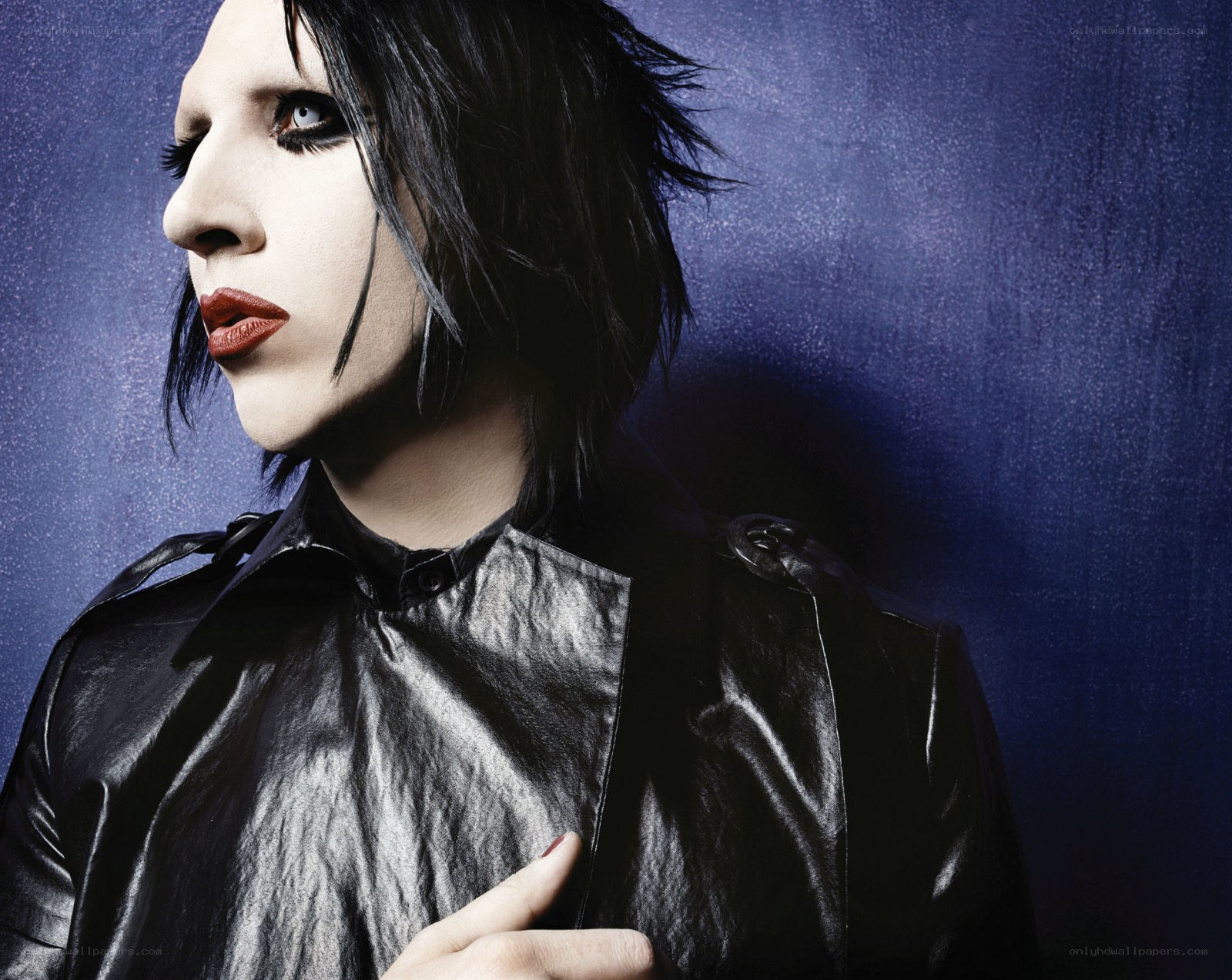 person with dark makeup and black jacket