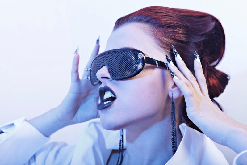person with dark makeup and goggles