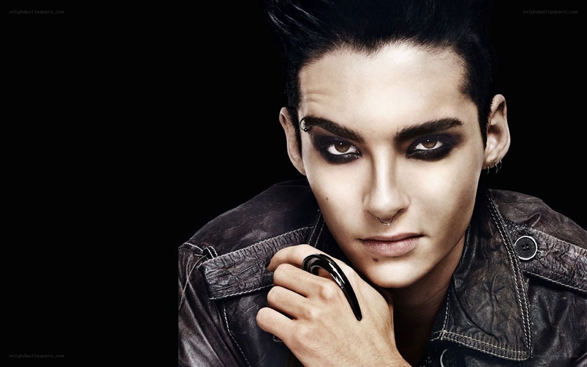 person with dark makeup and leather jacket