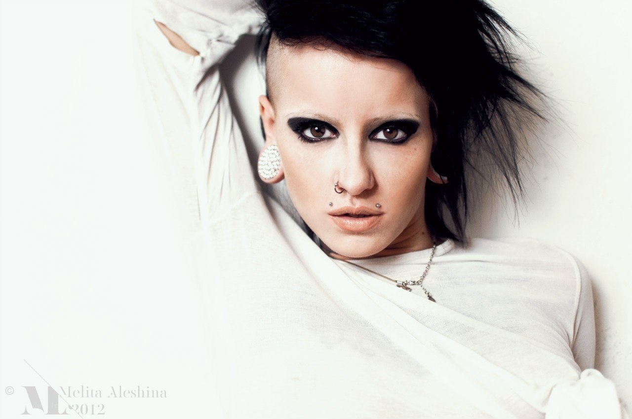 person with dark makeup and piercings