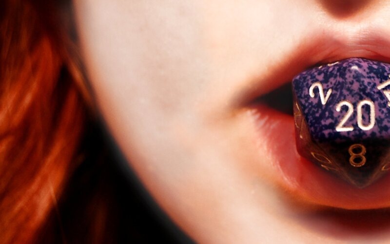 person with dice in mouth