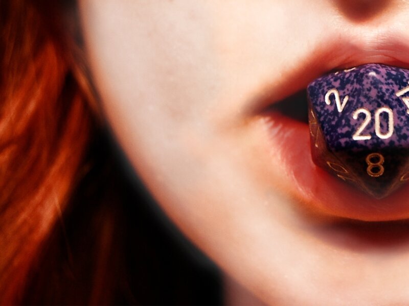 person with dice in mouth