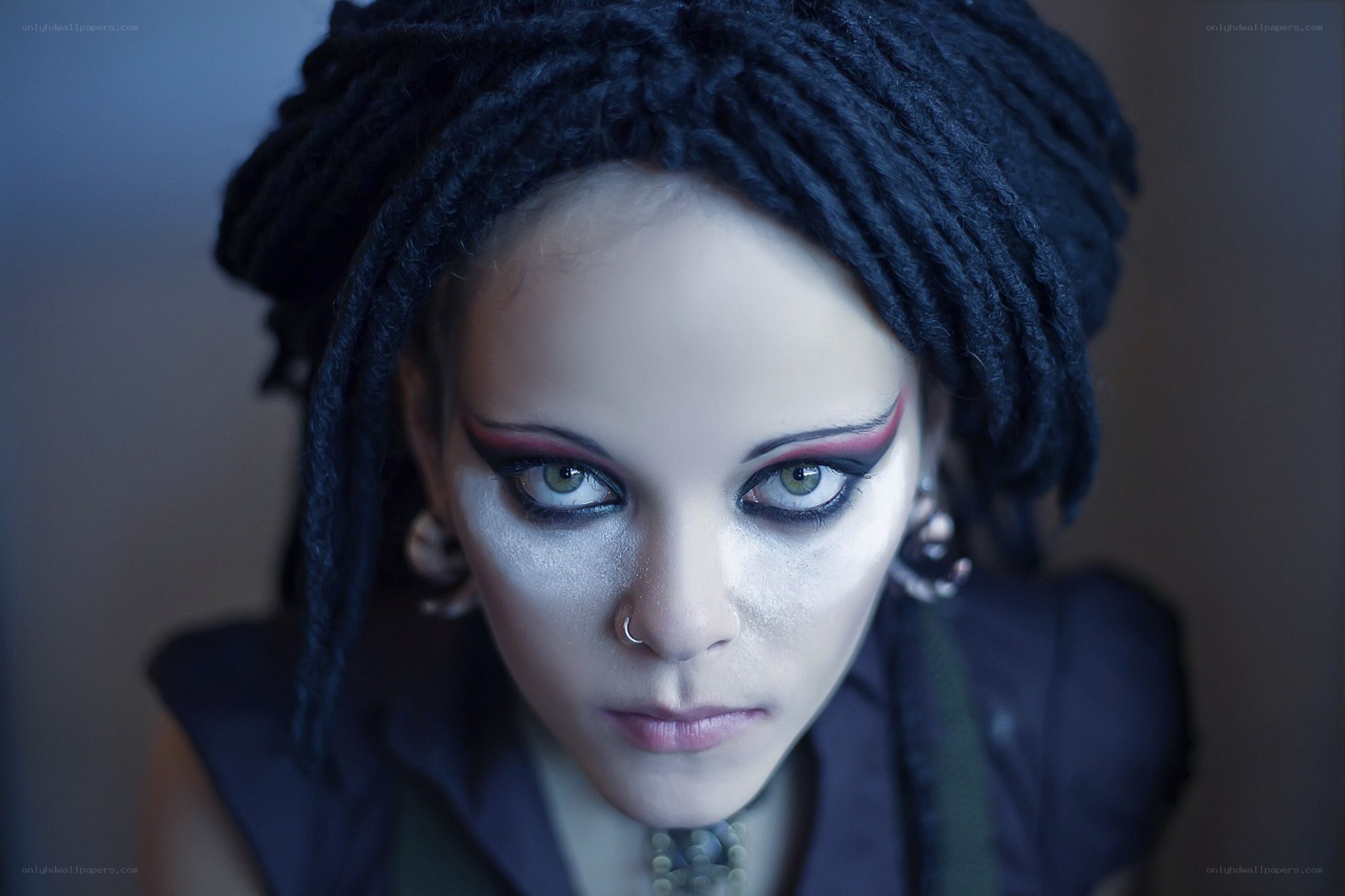 person with dreadlocks and dramatic makeup
