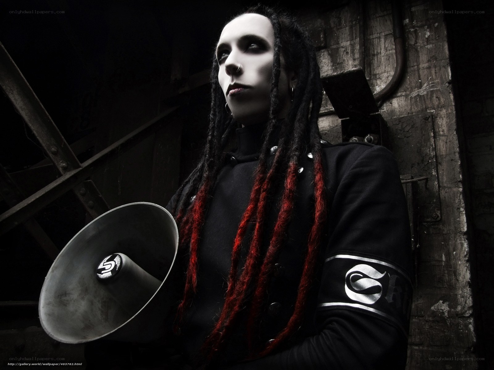 person with dreadlocks holding megaphone