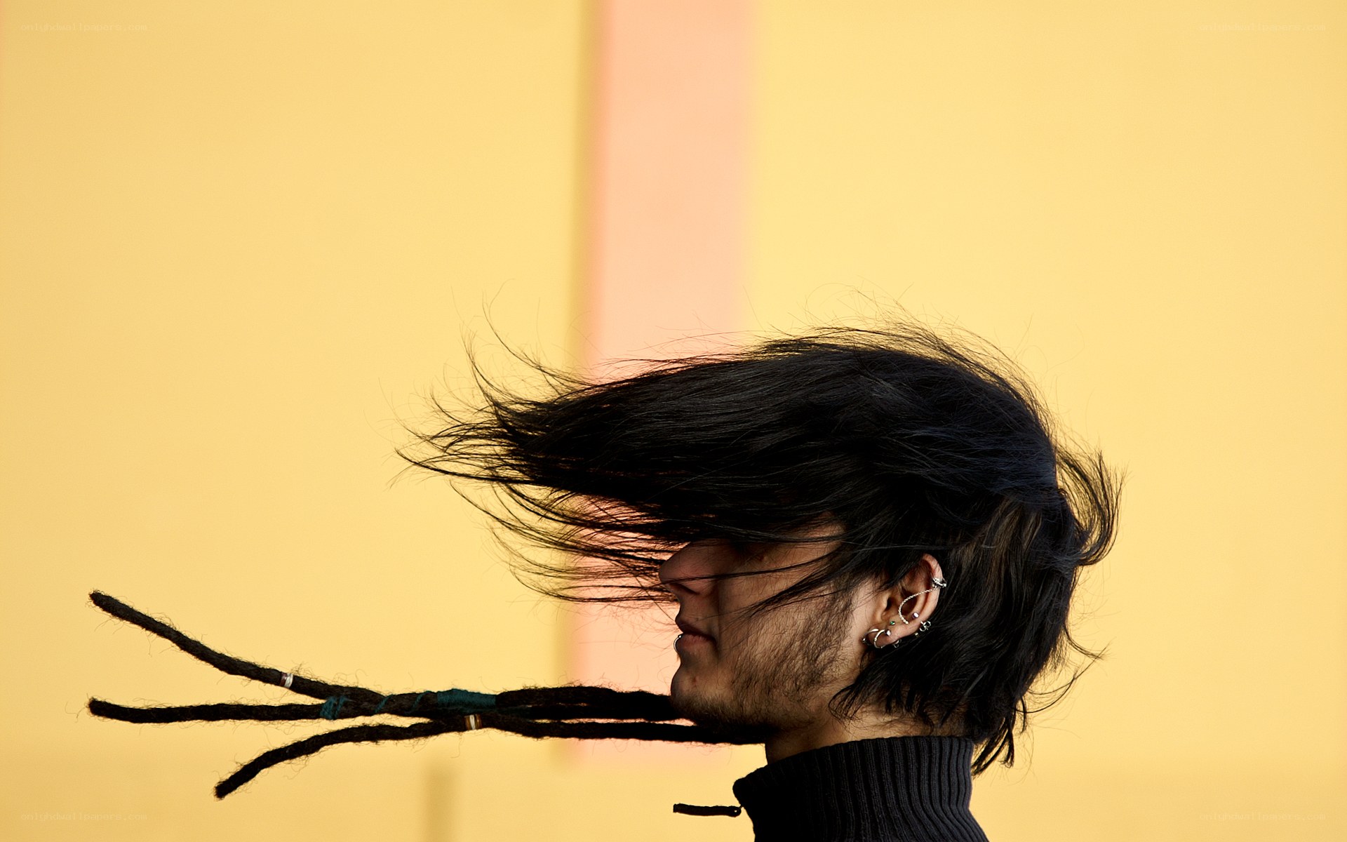 person with dreadlocks in wind