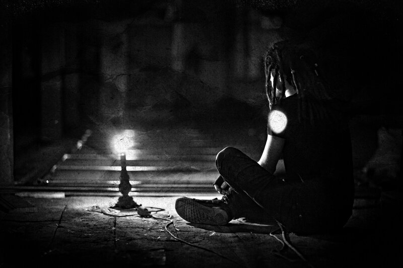 Person with Dreadlocks Sitting — Black
