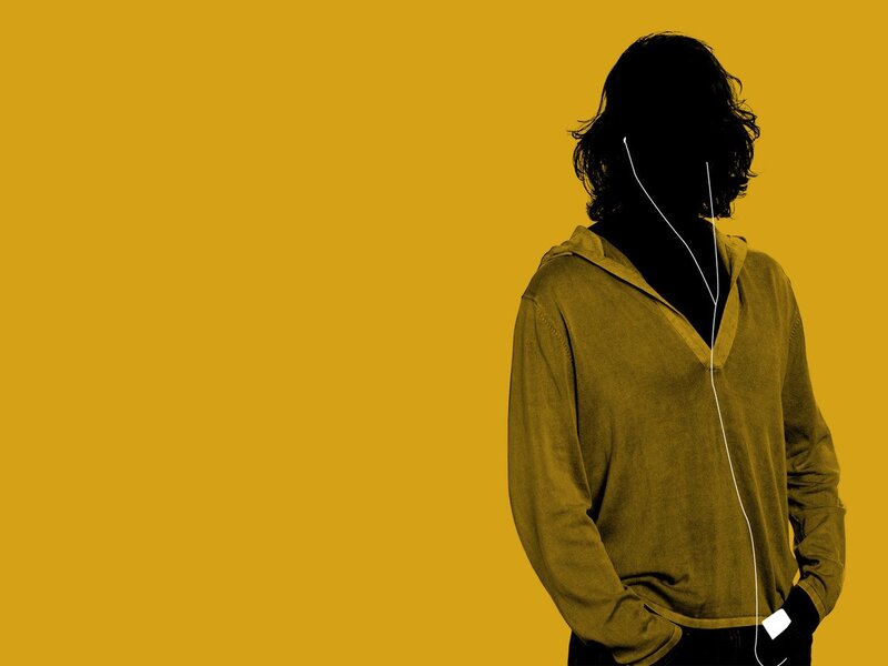 person with earphones on yellow