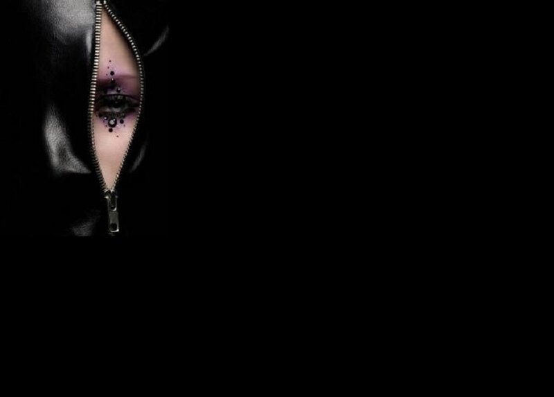 person with eye makeup and zipper