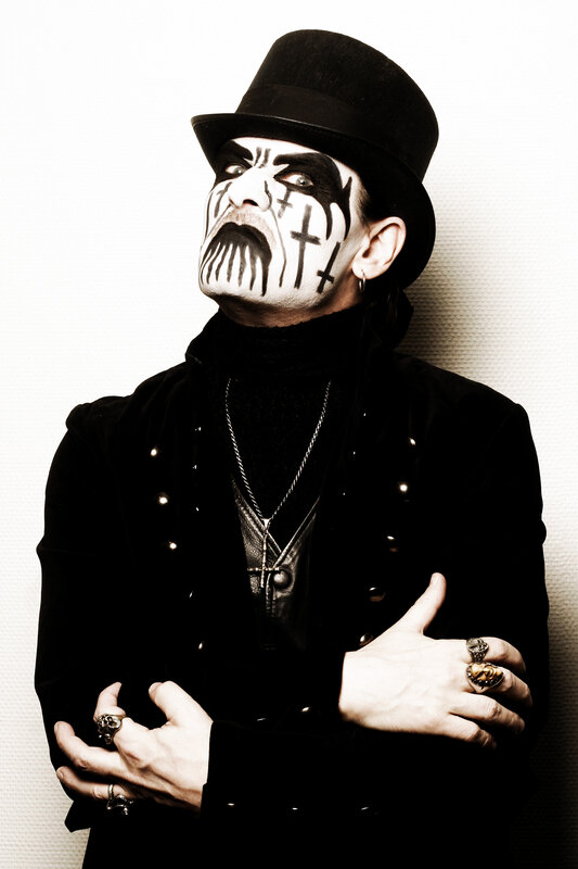 person with face paint and top hat