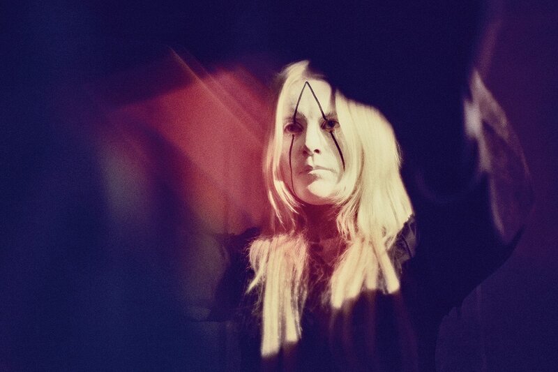 person with face paint in dark setting