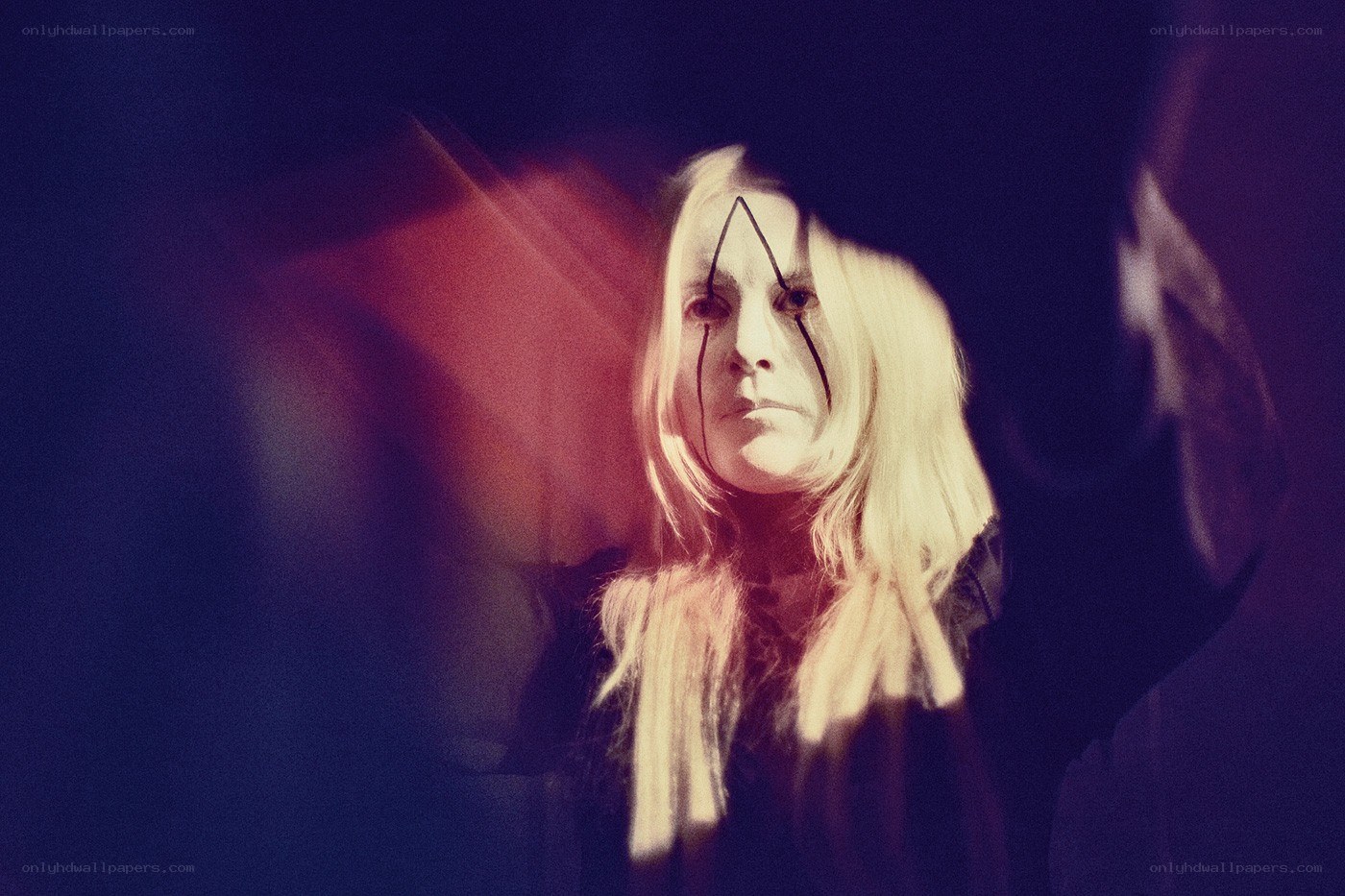 person with face paint in dark setting