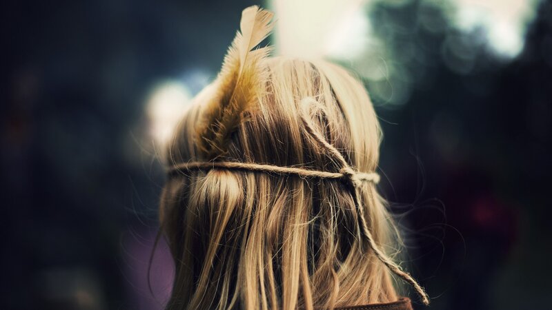 person with feather in hair