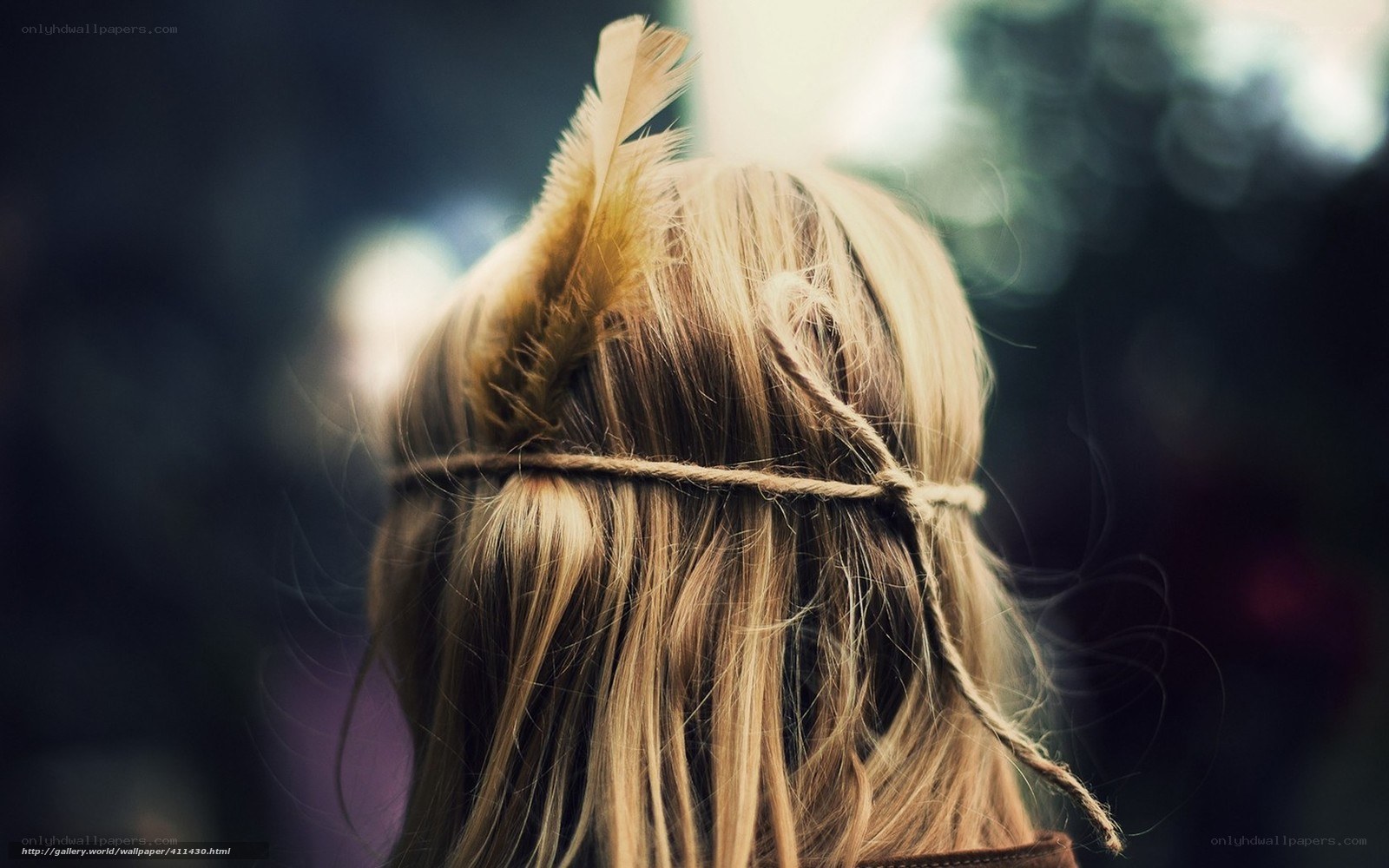 person with feather in hair