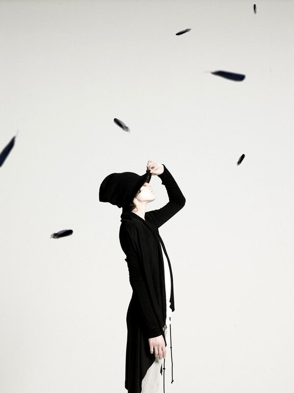 person with feathers falling