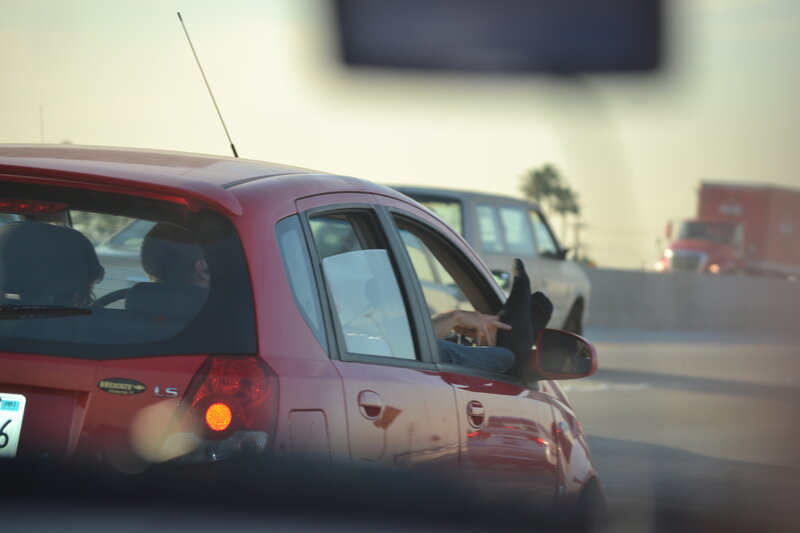 Person with Feet on Car Window