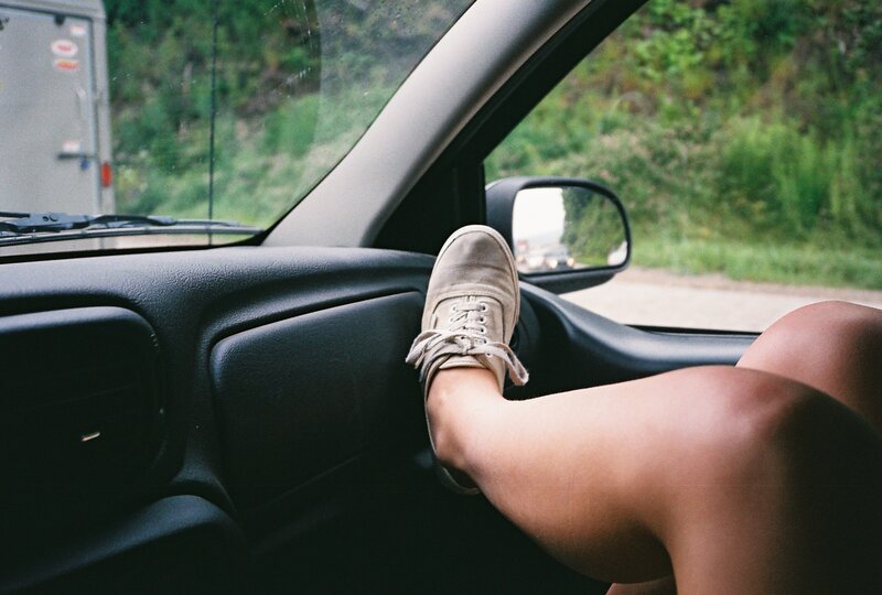 person with foot on car door