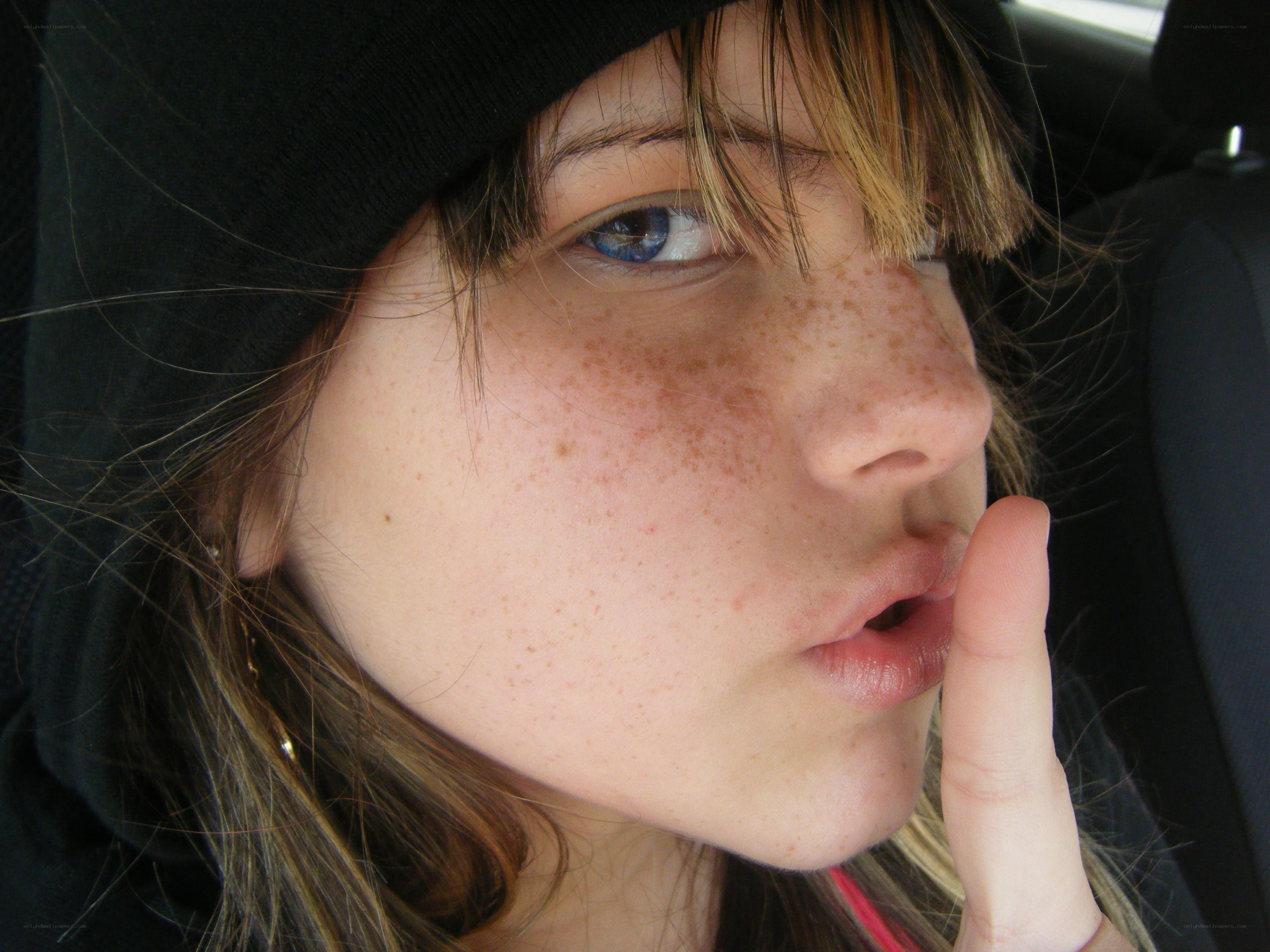 person with freckles in car