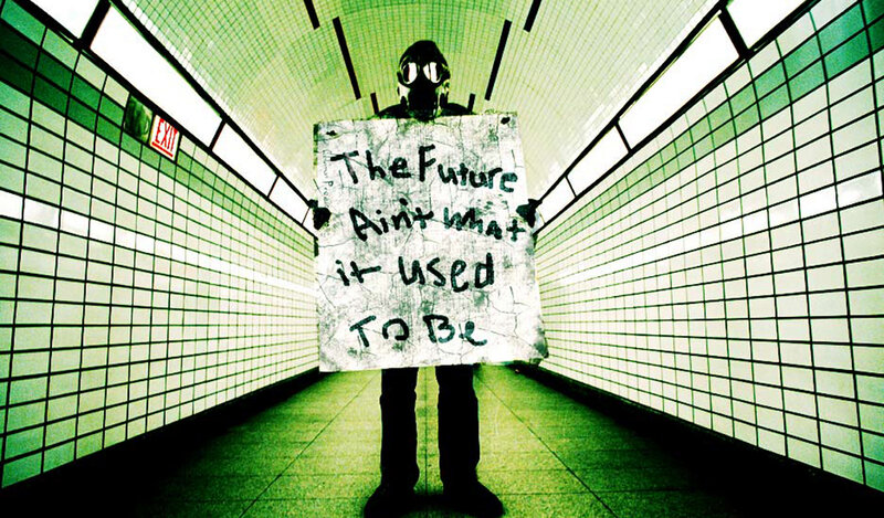 person with gas mask holding sign