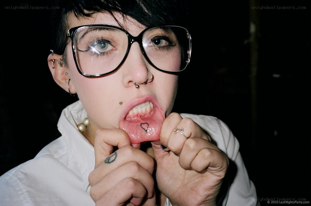 person with glasses and piercings