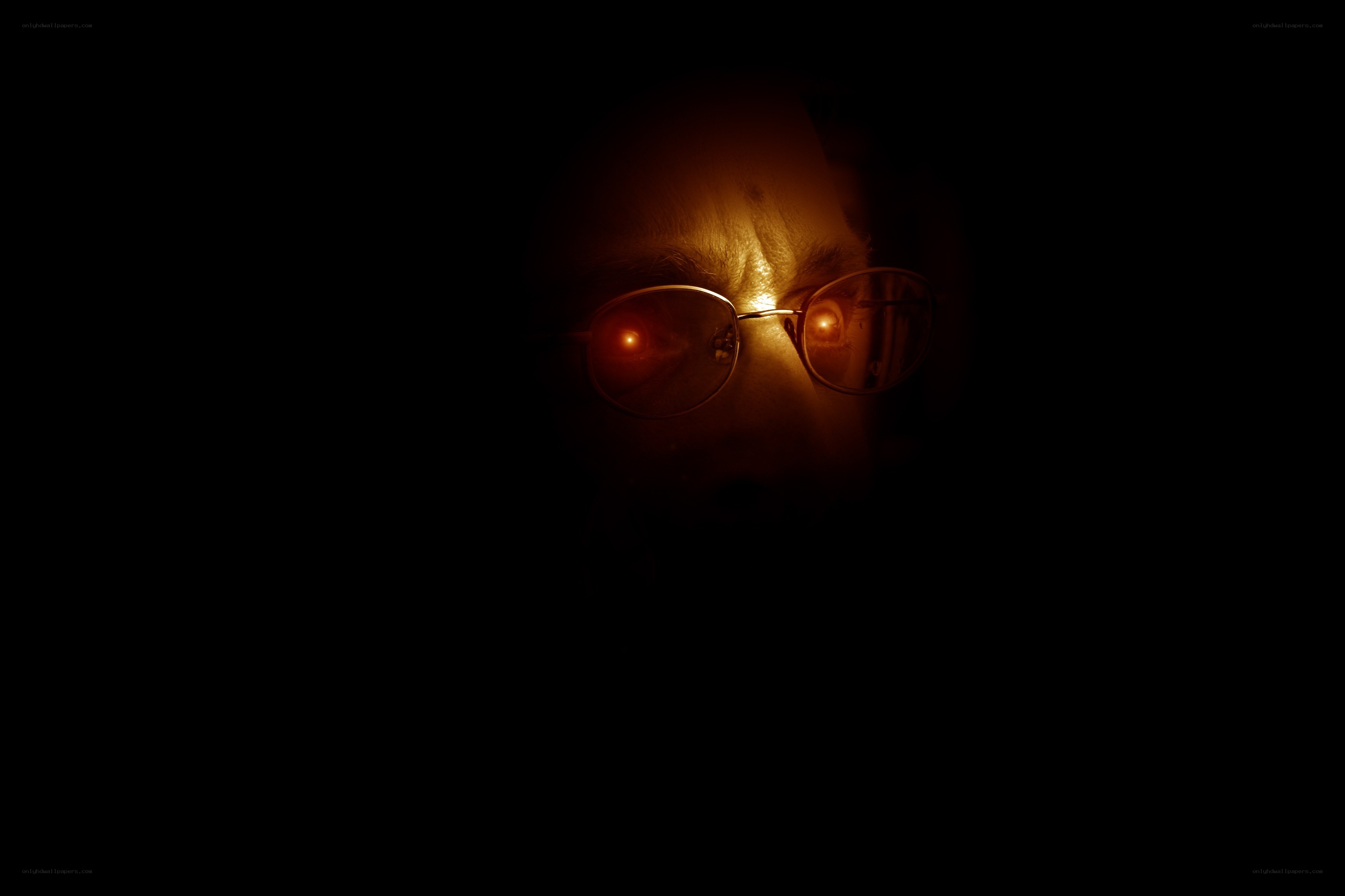 person with glasses in dark