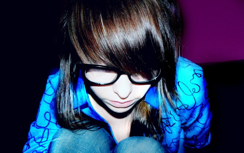 person with glasses looking down
